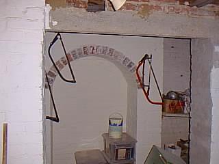 Cellar room 2 showing arch under fireplace.
